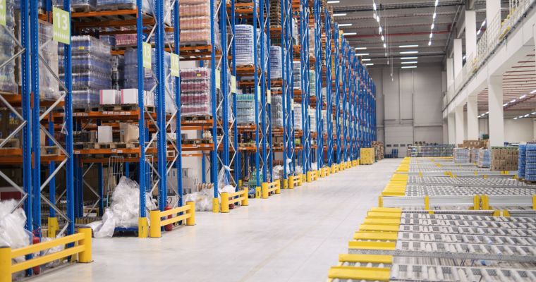 Warehouse storage interior with shelves loaded with goods.